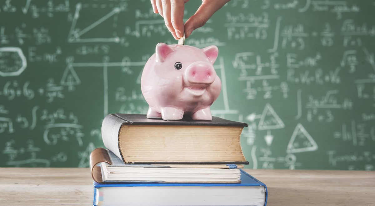 Female putting coin into piggy bank